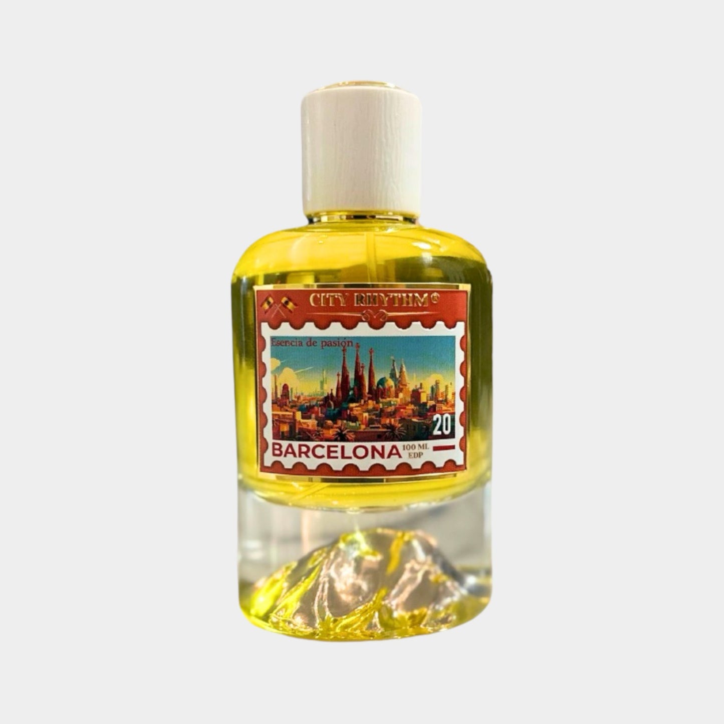 A full bottle of City Rhythm Barcelona perfume, featuring a vibrant label depicting the iconic skyline and landmarks of Barcelona. The bottle showcases a sleek design with a clear base and a white cap.