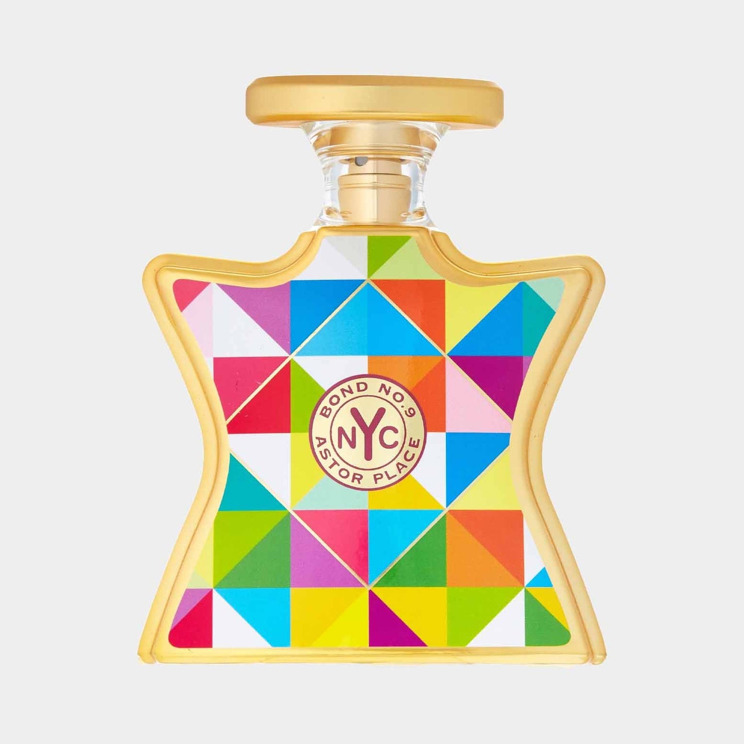 A colorful geometric bottle of Bond No. 9 Astor Place Sample perfume, featuring a vibrant design in shades of green, blue, red, and yellow. The bottle has a distinctive golden cap.