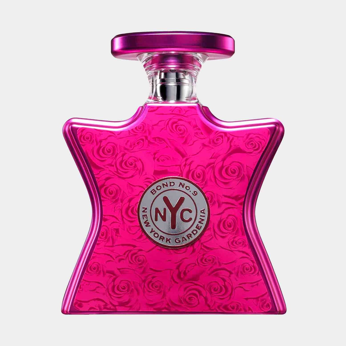 A full bottle of Bond No. 9 New York Gardenia, featuring a vibrant pink star-shaped design adorned with embossed roses and a silver logo at the center. The elegant bottle captures the essence of floral femininity.