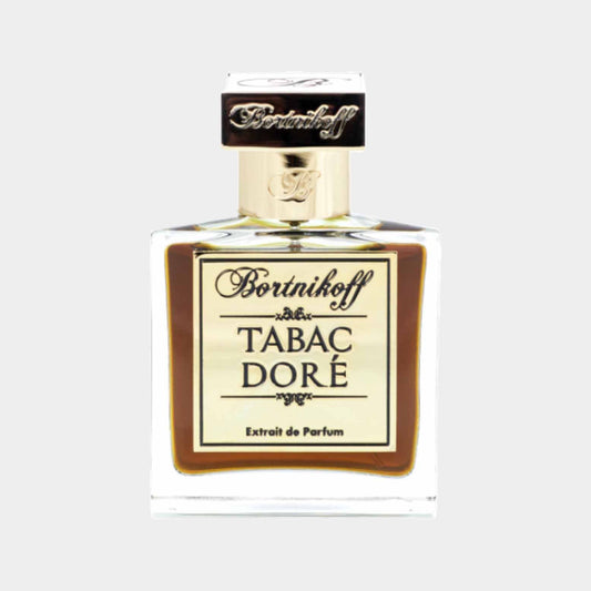 A glass perfume bottle of Bortnikoff Tabac Dore Sample featuring a gold label and ornate cap, showcasing a rich, amber liquid inside.