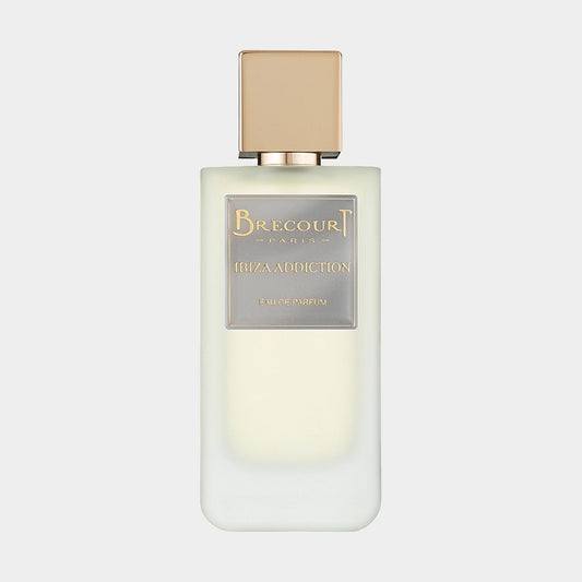 A sleek, pale bottle of Brecourt Ibiza Addiction Sample, featuring a minimalist design and a gold-accented label, encapsulating a luxurious fragrance experience.