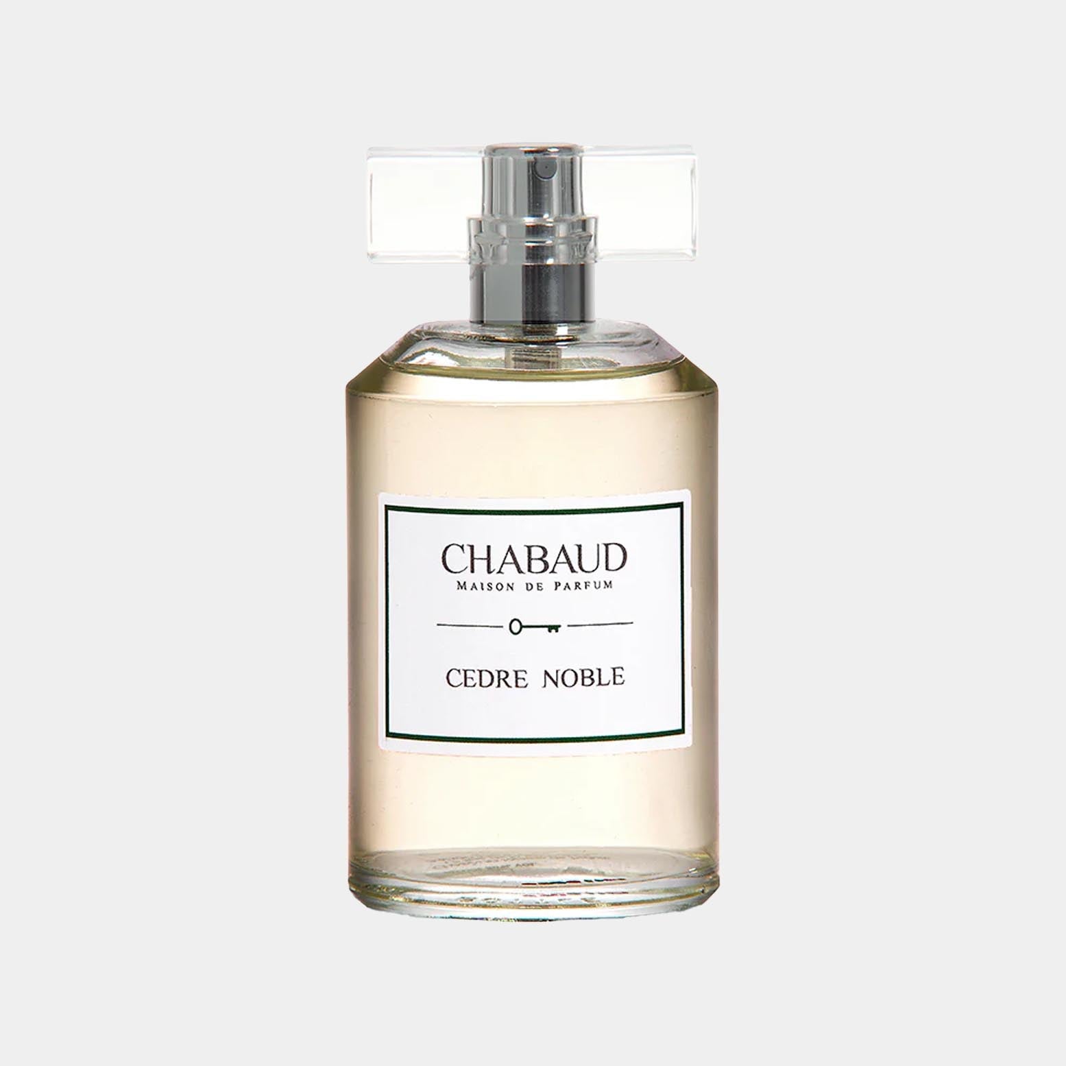 A clear perfume bottle labeled Chabaud Maison de Parfum Cedre Noble, featuring a streamlined design and a simple silver cap, showcasing a light, amber-colored liquid inside.