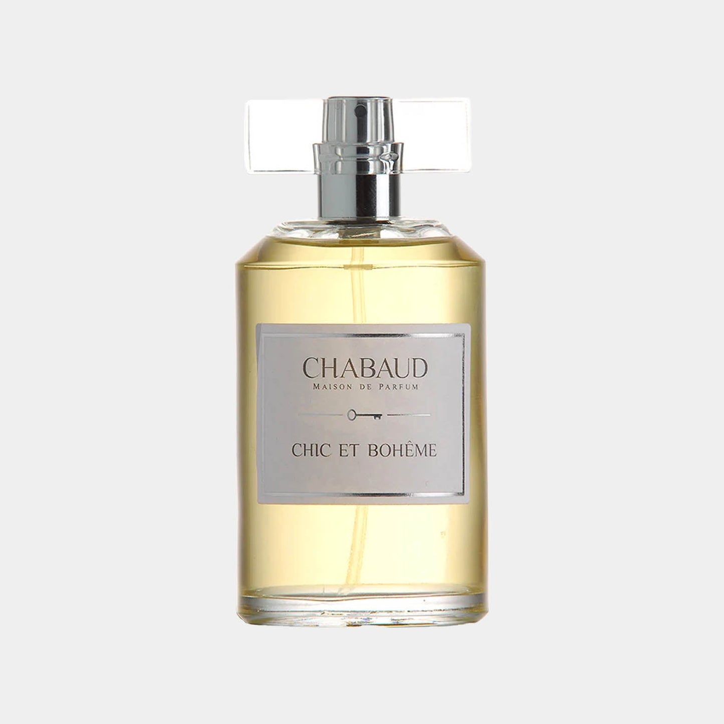 Chabaud Maison de Parfum Chic et Bohème sample features an elegant glass bottle with a square, transparent cap and a label that highlights its name. The fragrance inside is a warm, inviting yellow hue, suggesting sophistication and artistry.
