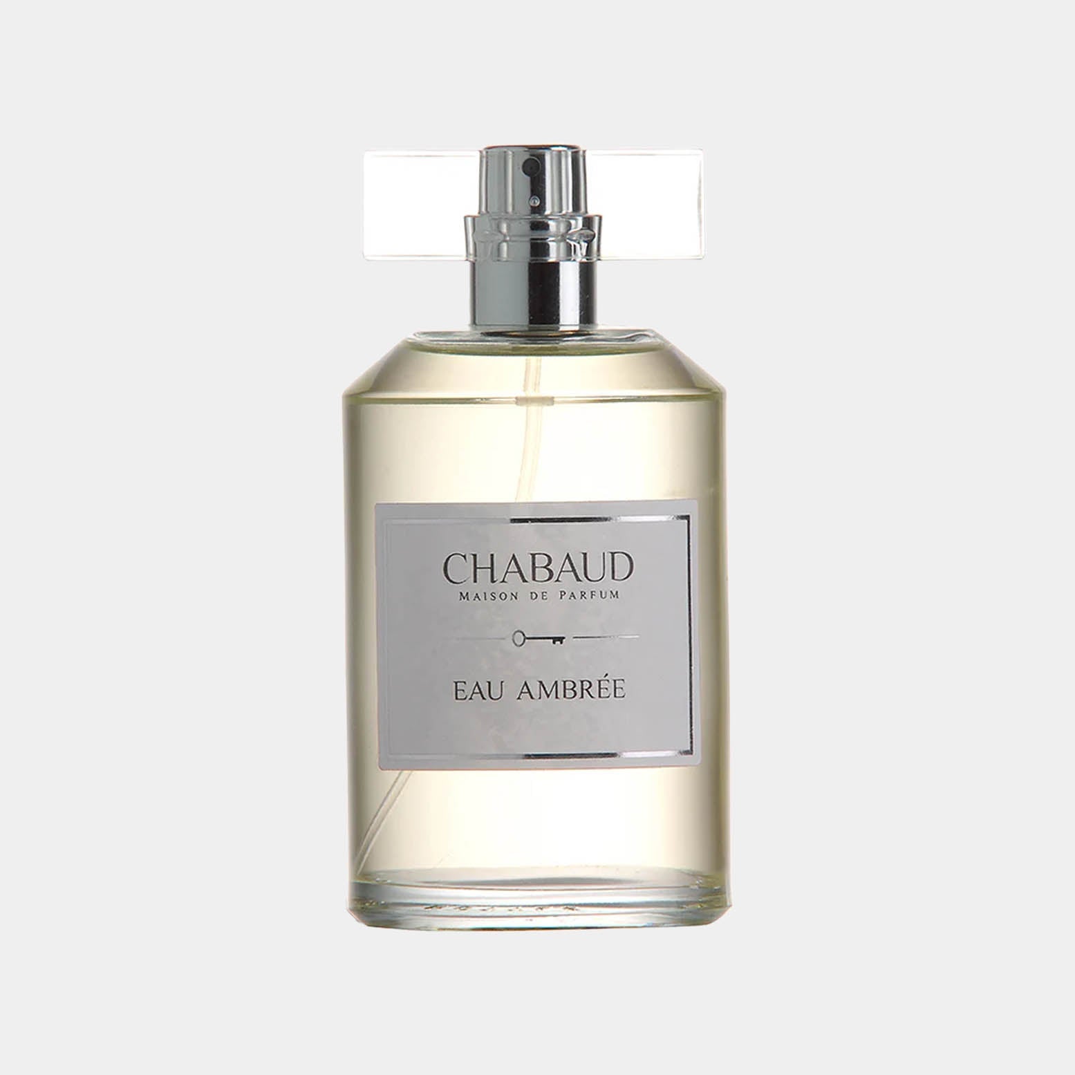 A sleek glass bottle of Chabaud Maison de Parfum Eau Ambrée Sample, featuring a silver label and a transparent cap, showcasing the elegant fragrance within. The bottle's minimalist design reflects the sophistication of the scent.