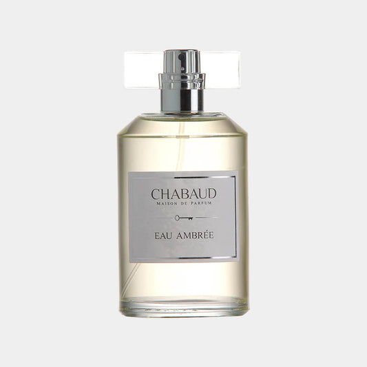 A sleek glass bottle of Chabaud Maison de Parfum Eau Ambrée Sample, featuring a silver label and a transparent cap, showcasing the elegant fragrance within. The bottle's minimalist design reflects the sophistication of the scent.