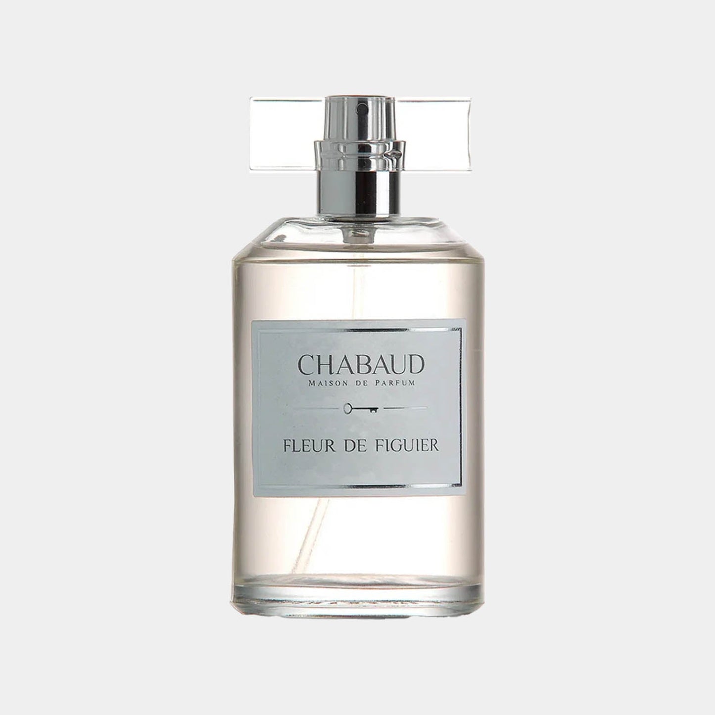 A clear bottle labeled Chabaud Maison de Parfum Fleur de Figuier Sample, featuring a sleek design and a silver cap, containing a translucent fragrance.