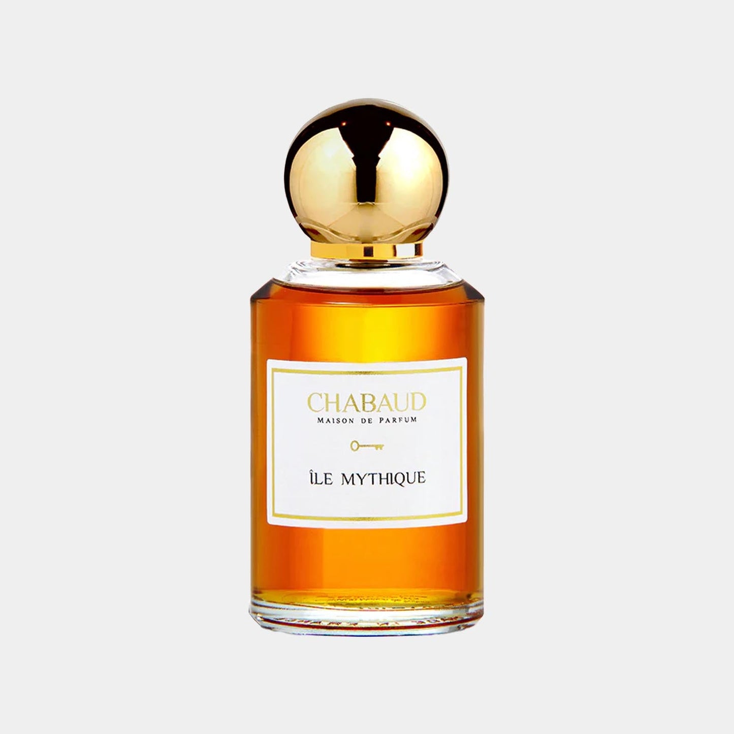 A luxurious perfume bottle from Chabaud Maison de Parfum labeled Île Mythique, featuring an elegant design with a golden cap and amber liquid inside.