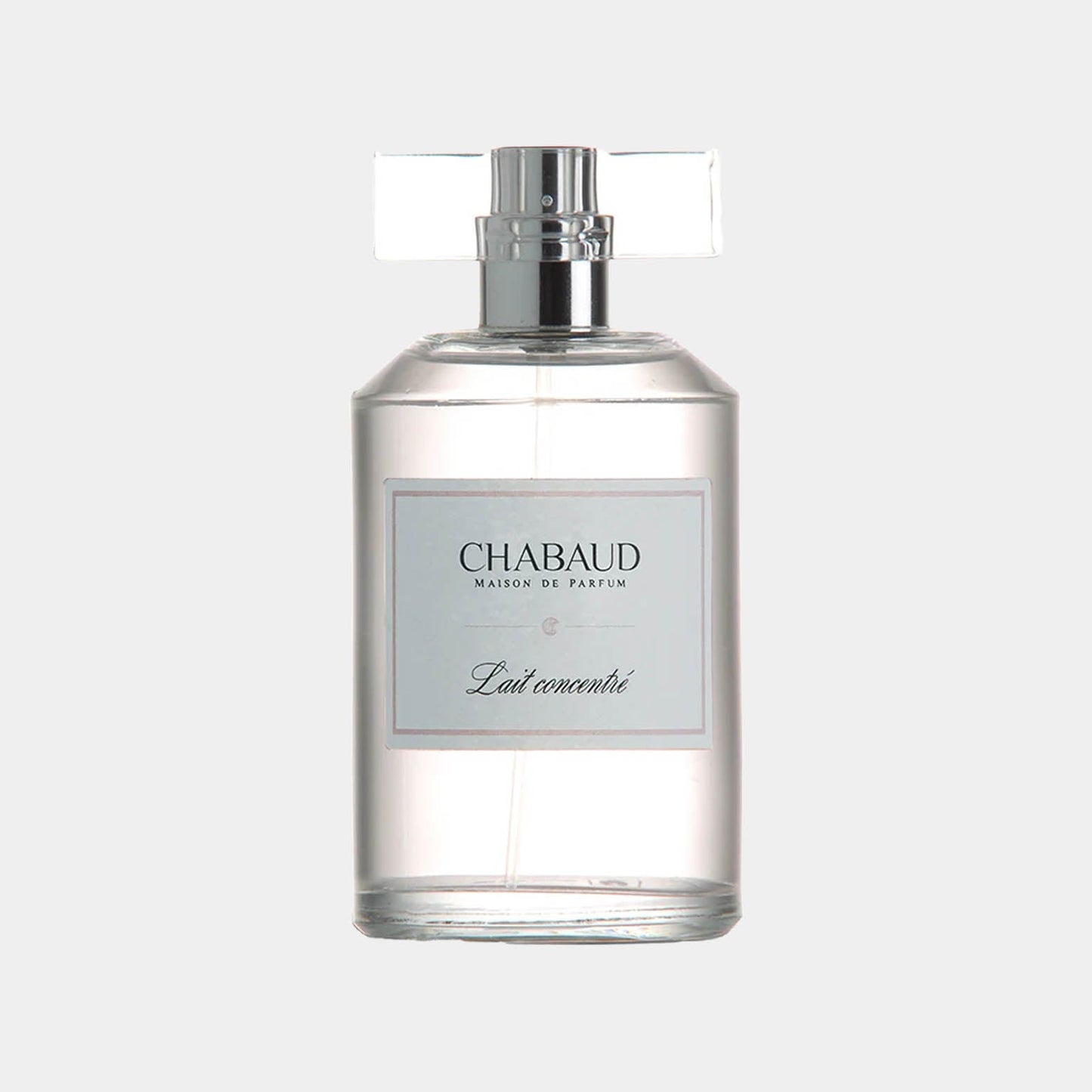 A clear glass bottle of Chabaud Maison de Parfum Lait Concentre EDT Sample, featuring a minimalist label and a sleek design. The bottle is designed for easy display and sampling of the fragrance.