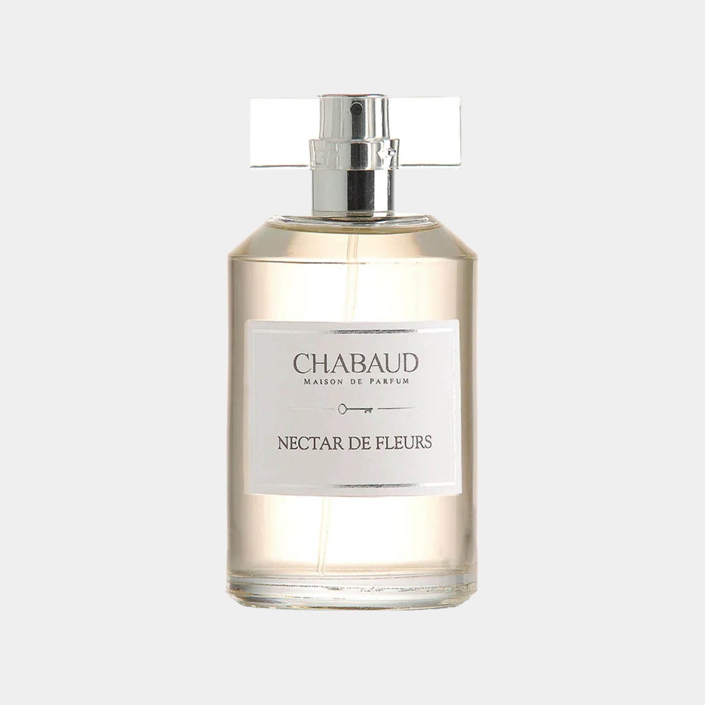 A sample bottle of Chabaud Maison de Parfum Nectar de Fleurs, featuring a sleek design with a silver cap and a clear label. The fragrance is delicately showcased in a transparent bottle, capturing the essence of floral notes.