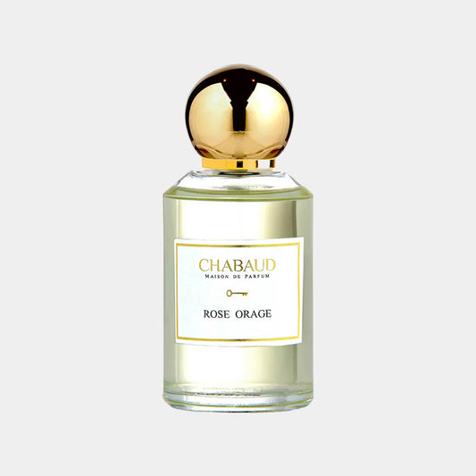 A clear glass perfume bottle with a gold cap, labeled Chabaud Maison de Parfum Rose Orage Sample, showcasing a light yellow liquid inside.