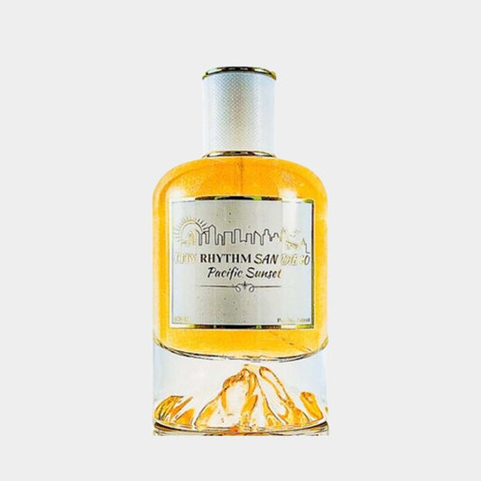 A glass bottle of City Rhythm San Diego Sample fragrance, featuring a warm amber liquid and a sleek design with a gold-label that reads Pacific Sunset.