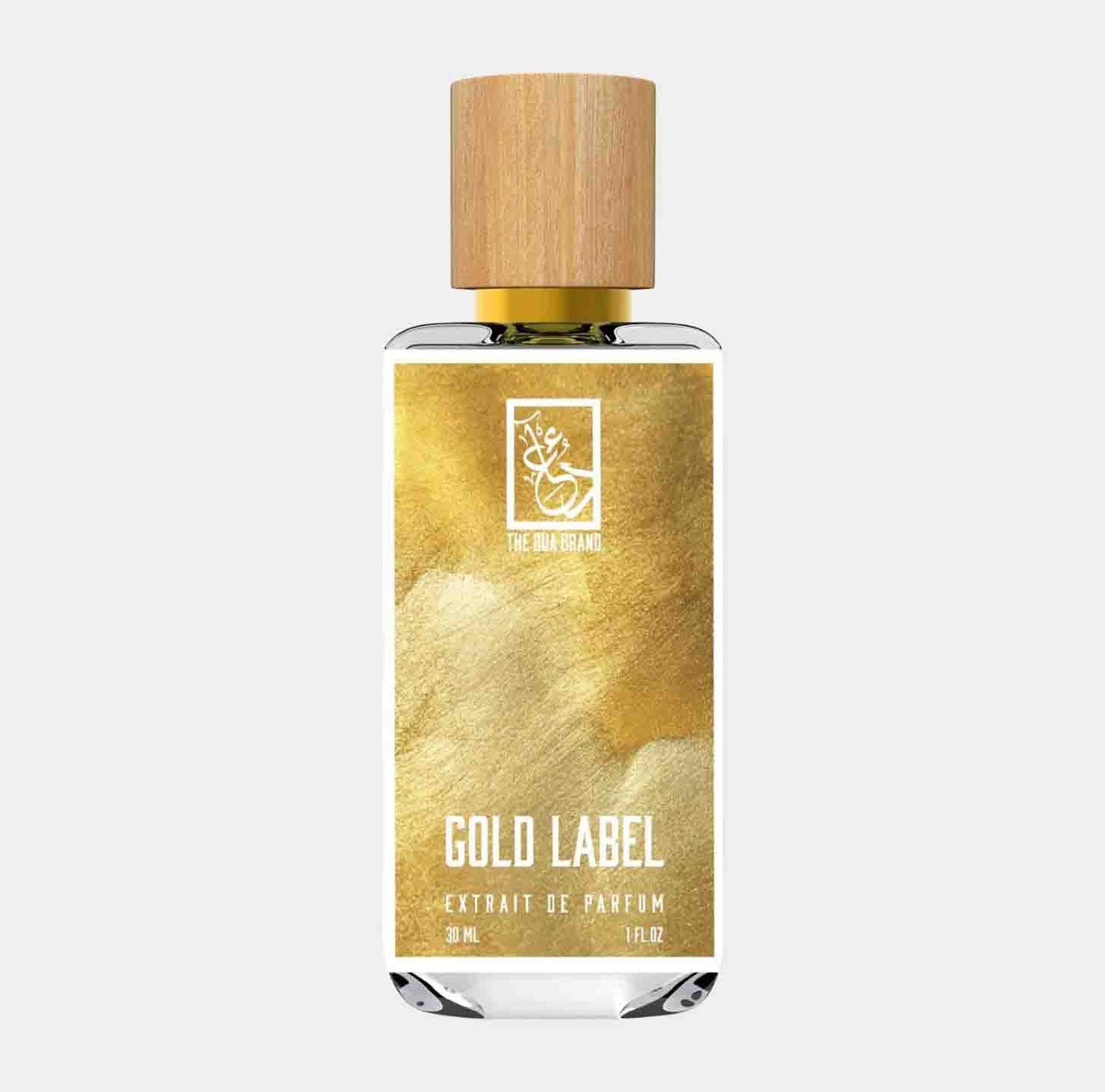 A sleek glass bottle of Dua Gold Label Sample perfume, featuring a wooden cap and a gold and white label that reads Gold Label Extrait de Parfum. The bottle holds 30 mL of fragrance.