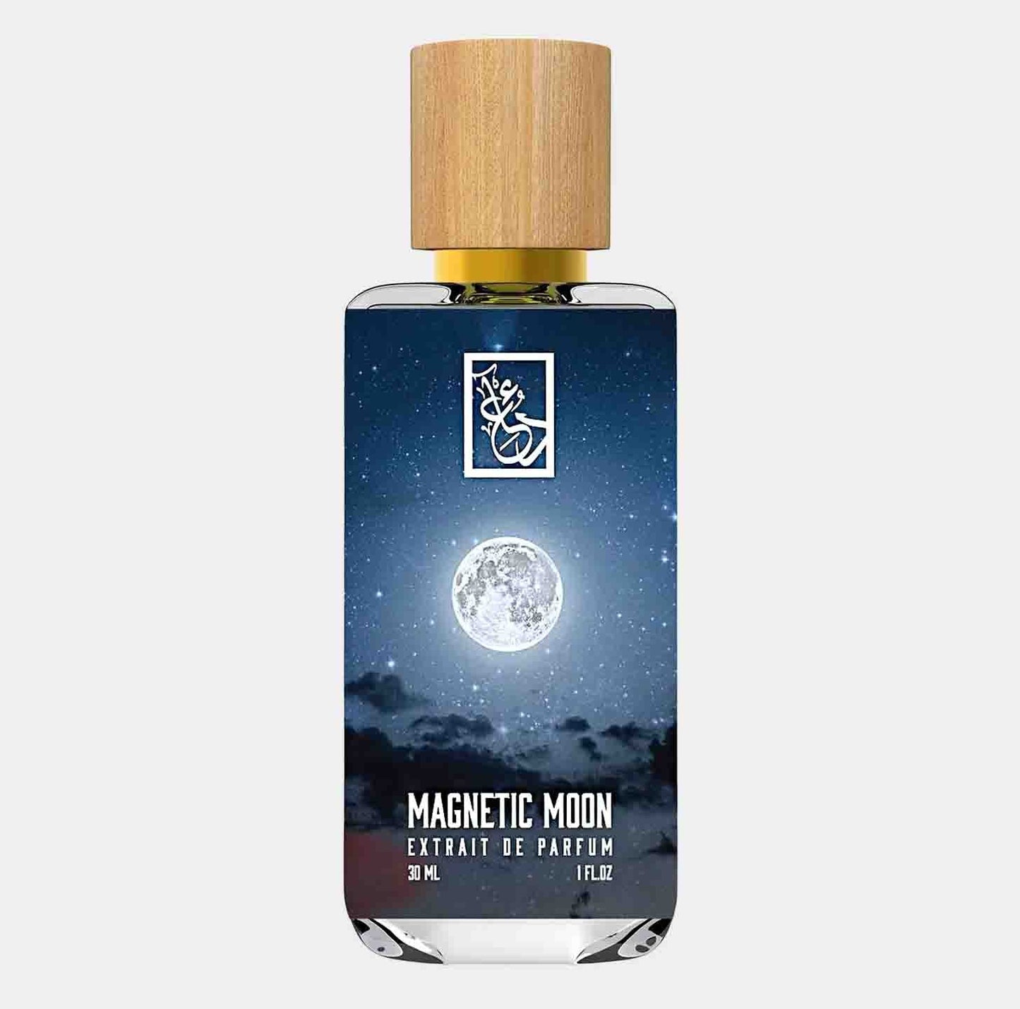 A sleek bottle of Dua Magnetic Moon Sample, featuring a wooden cap and a deep blue label adorned with a moonlit sky. The bottle contains 30 mL of extrait de parfum.