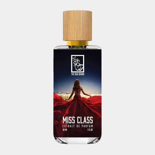 Dua Miss Class Sample, a 30 ml extrait de parfum, featuring a stunning bottle with a wooden cap and an elegant image of a woman in a red dress against a nighttime cityscape.