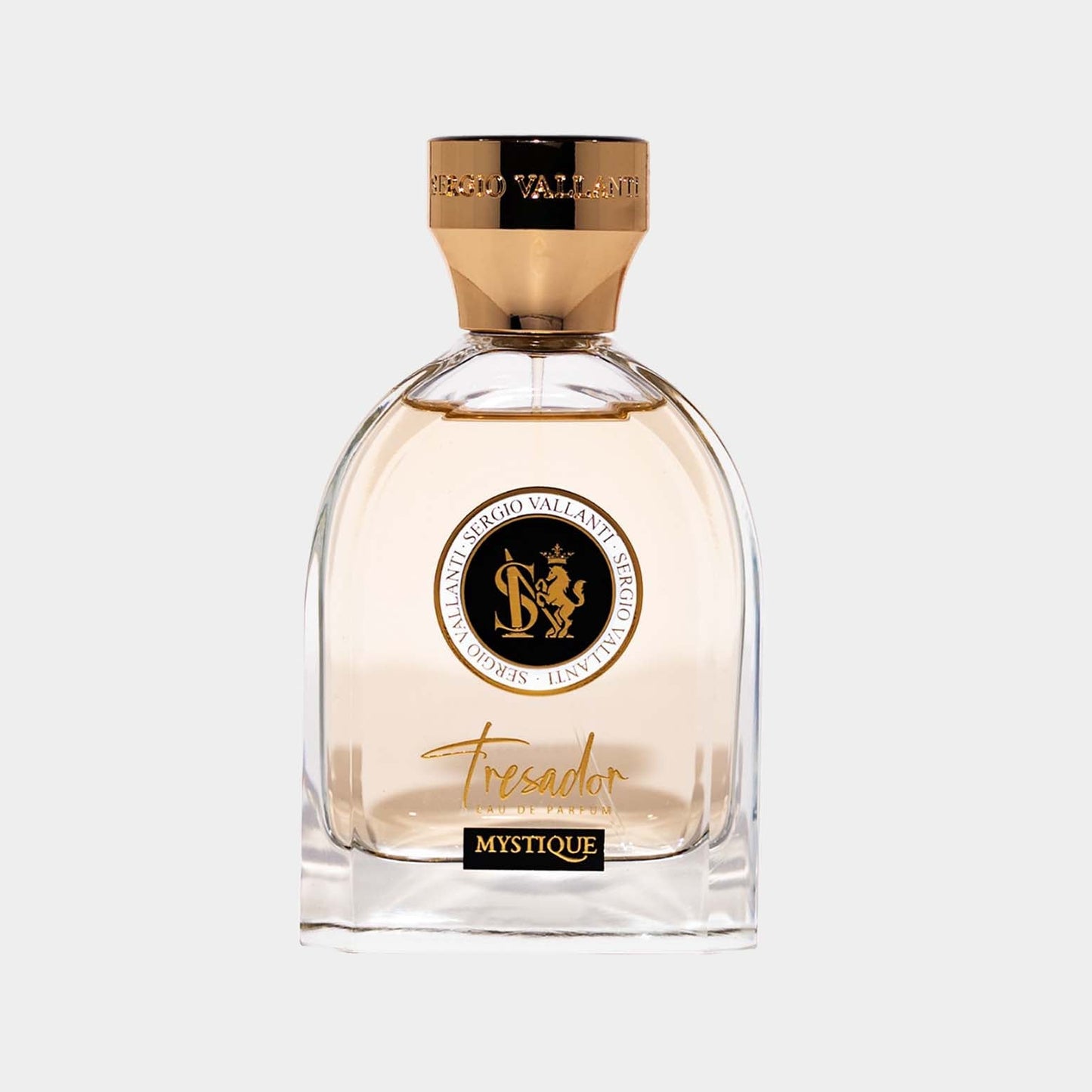 A clear glass bottle of Tresador Mystique Sample featuring a gold-capped top and an elegant design, showcasing the luxurious fragrance inside. The bottle is adorned with the Tresador logo, emphasizing its premium quality.