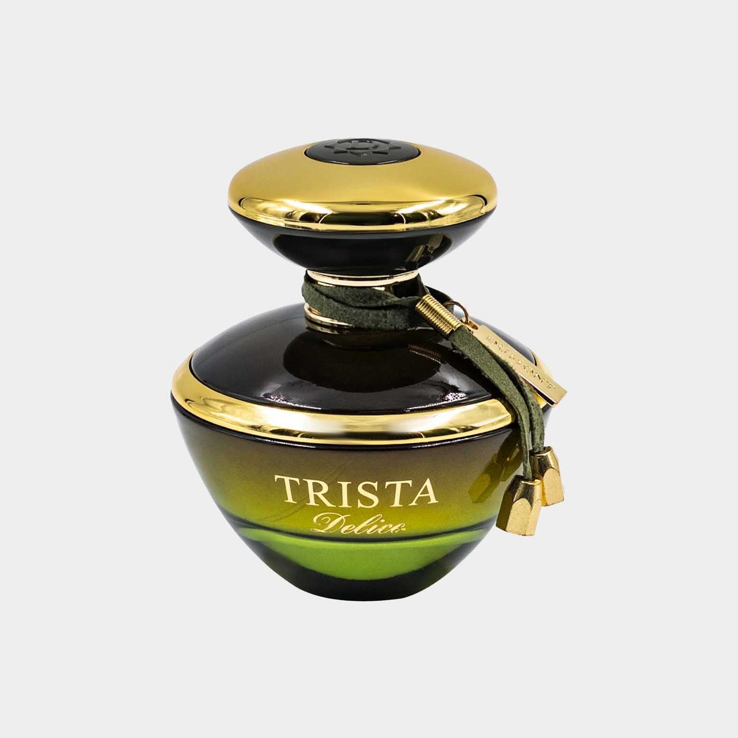 A full bottle of Trista Delice perfume, featuring a rounded base in green and black with a gold cap and a decorative gold charm.