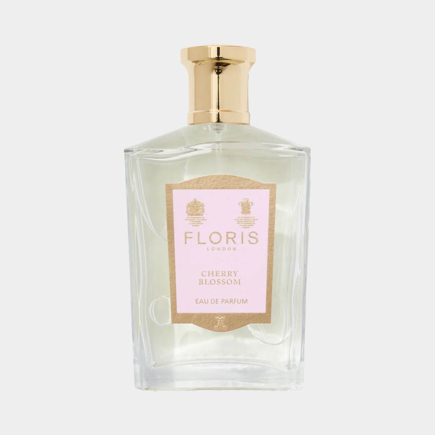 A clear glass bottle of Floris London Cherry Blossom perfume, featuring a gold cap and a soft pink label, showcasing the fragrance's elegant design.