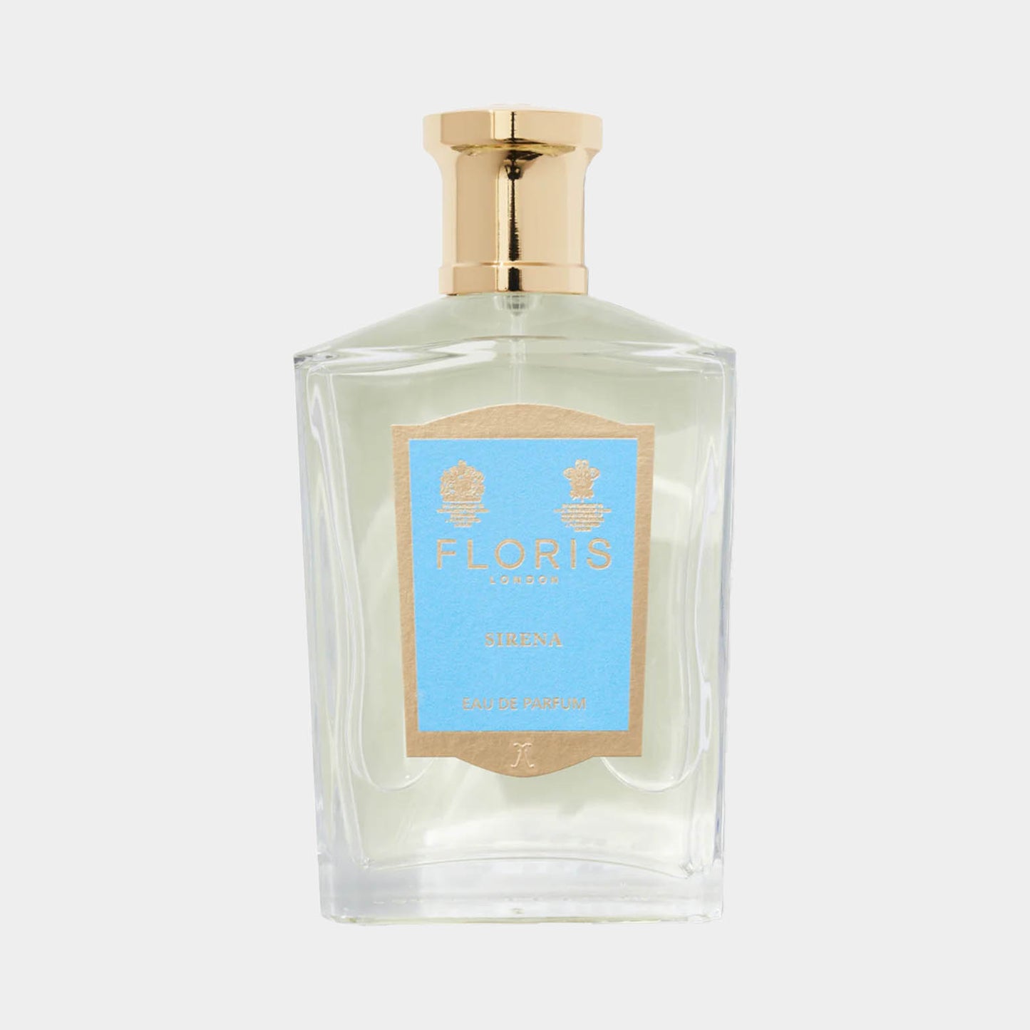 A transparent glass bottle of Floris London Sirena Sample perfume, featuring a light blue label and a gold cap, set against a simple background.