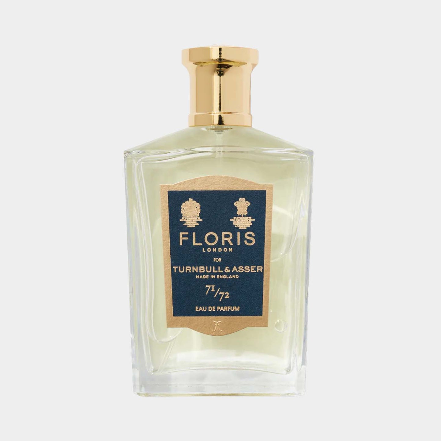 A clear glass bottle of Floris London 71/72 Sample, featuring a gold cap and a decorative label that highlights its collaboration with Turnbull & Asser. The fragrance is presented as an elegant eau de parfum.