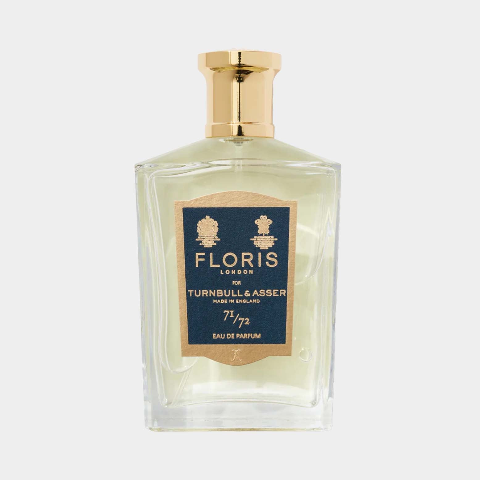 A clear glass bottle of Floris London 71/72 Sample, featuring a gold cap and a decorative label that highlights its collaboration with Turnbull & Asser. The fragrance is presented as an elegant eau de parfum.