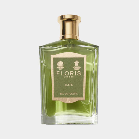 A stylish glass flask featuring the Floris London Elite Sample perfume, showcasing a light green liquid and an elegant gold cap, with a neutral background.