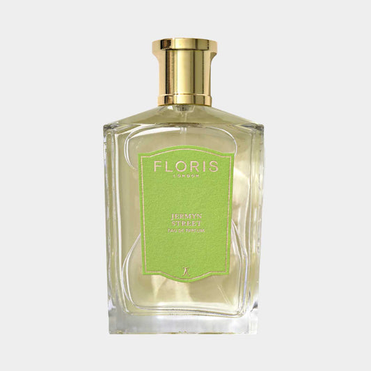A glass bottle of Floris London Jermyn Street Sample fragrance, featuring a sleek design and a green label, showcasing its luxurious and elegant appeal.