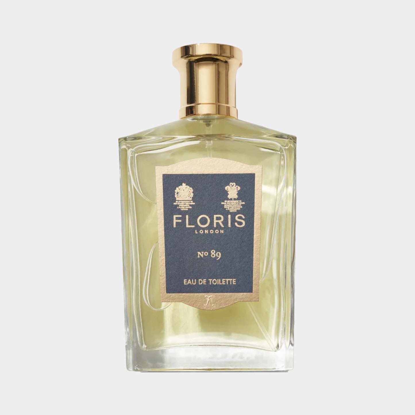 A clear glass bottle of Floris London No. 89 Eau de Toilette, featuring a gold cap and a blue label with elegant gold lettering.