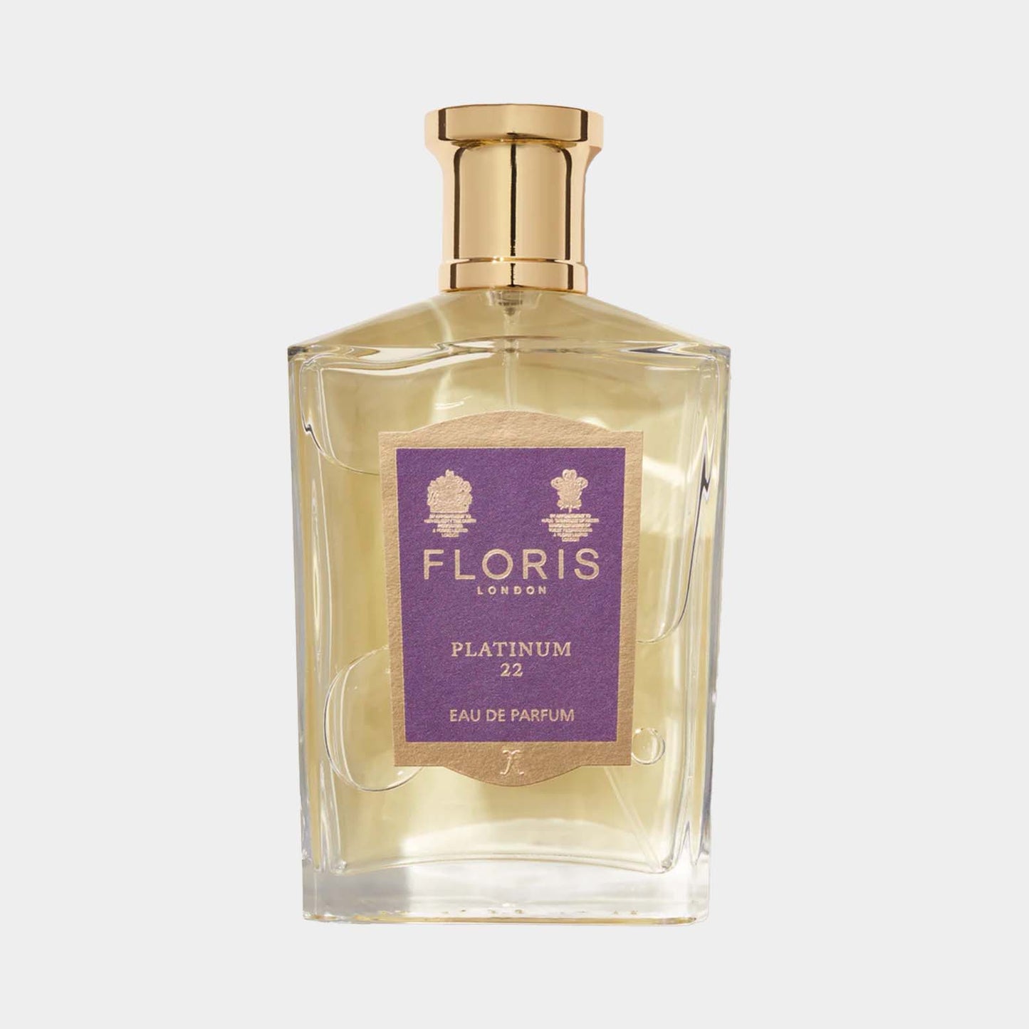 A sleek glass bottle of Floris London Platinum 22 Eau de Parfum, featuring a gold cap and a purple label showcasing its name. The fragrance exudes elegance and sophistication.