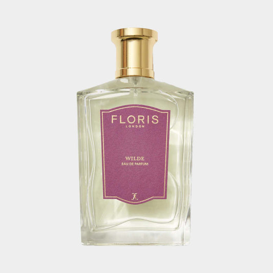 A clear glass bottle of Floris London Wilde Sample fragrance, featuring a purple label and a gold cap. The scent is categorized as Eau de Parfum.