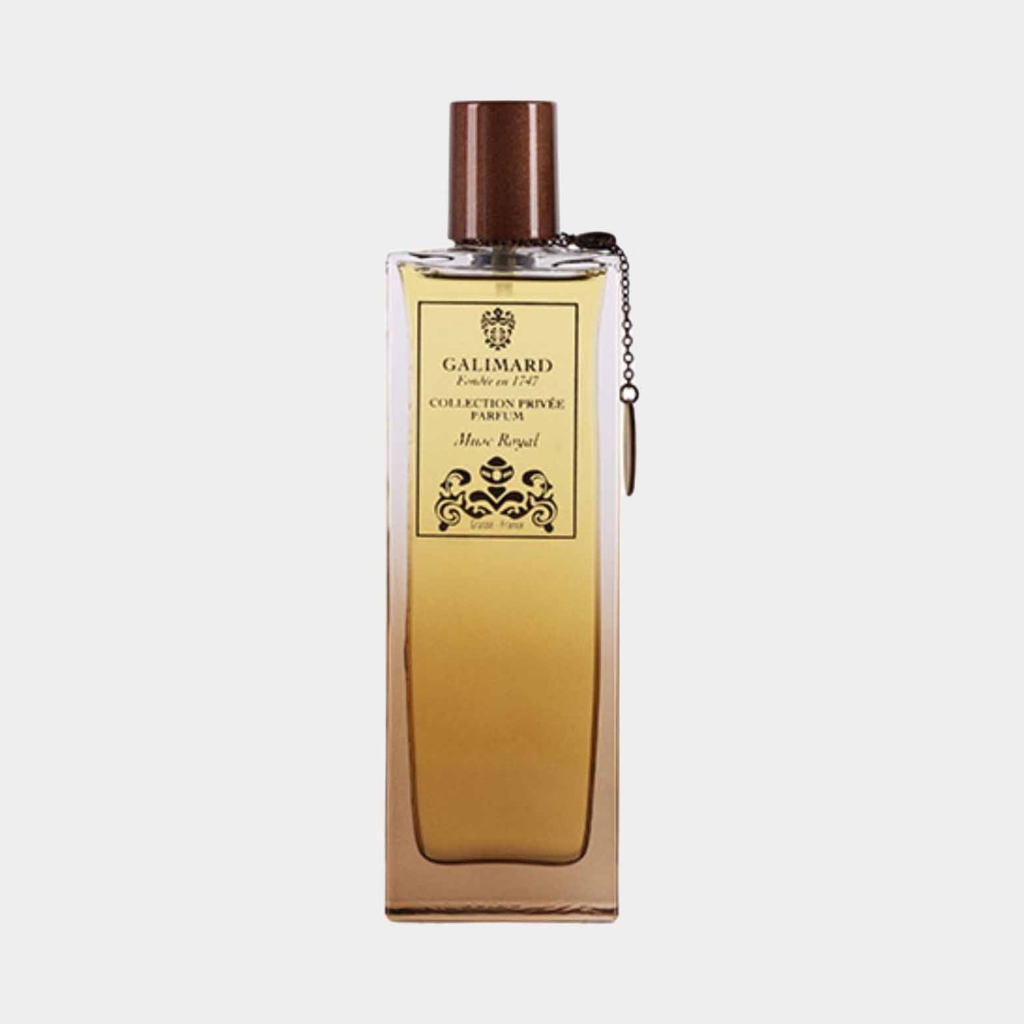 A bottle of Galimard Musc Royal Collection Privée Sample, featuring a sleek design with a golden liquid and a stylish brown cap, showcasing its luxurious fragrance.