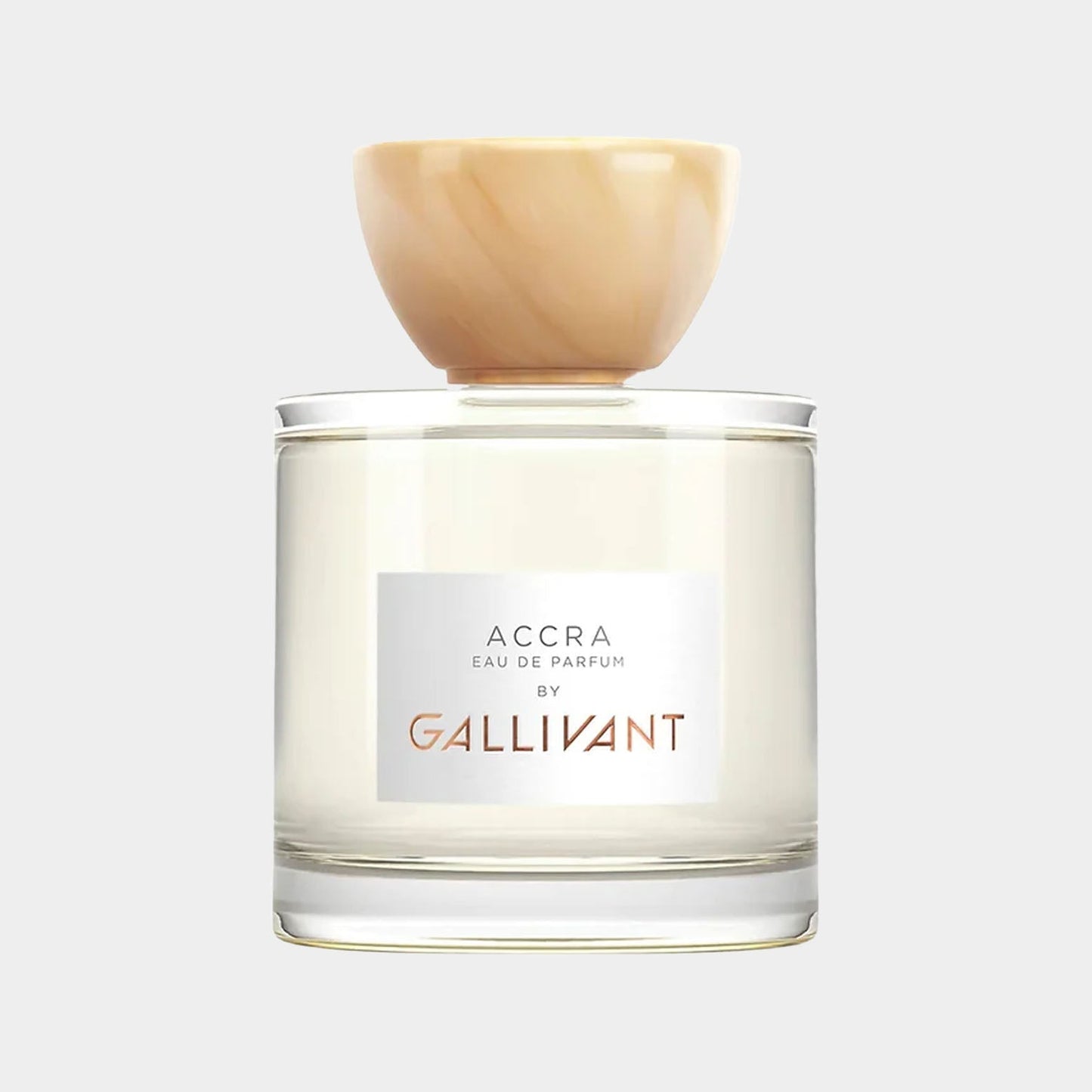 A clear glass perfume bottle of Gallivant Accra Sample featuring a minimalist design and a light-colored wooden cap. The label reads Accra Eau de Parfum by Gallivant, showcasing the fragrance inside.
