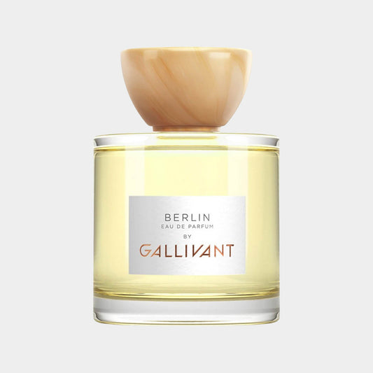 A full bottle of Gallivant Berlin Eau de Parfum, featuring a clear glass container with a light yellow liquid and a stylish, rounded wooden cap. The label prominently displays Berlin and by Gallivant.