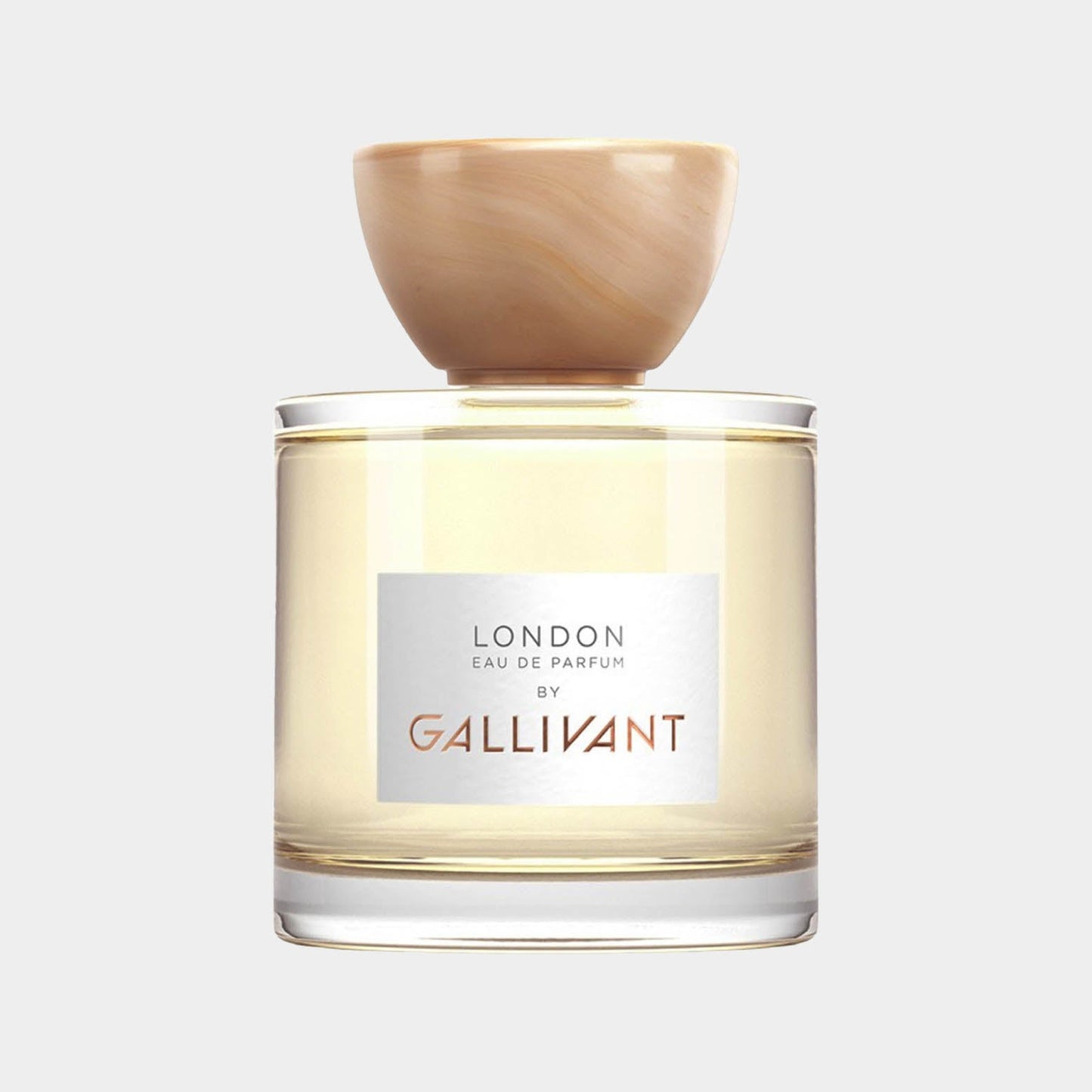 Gallivant London full bottle is an elegant glass perfume container featuring a light yellow liquid and a distinctive round wooden cap, showcasing the brand's minimalist design.