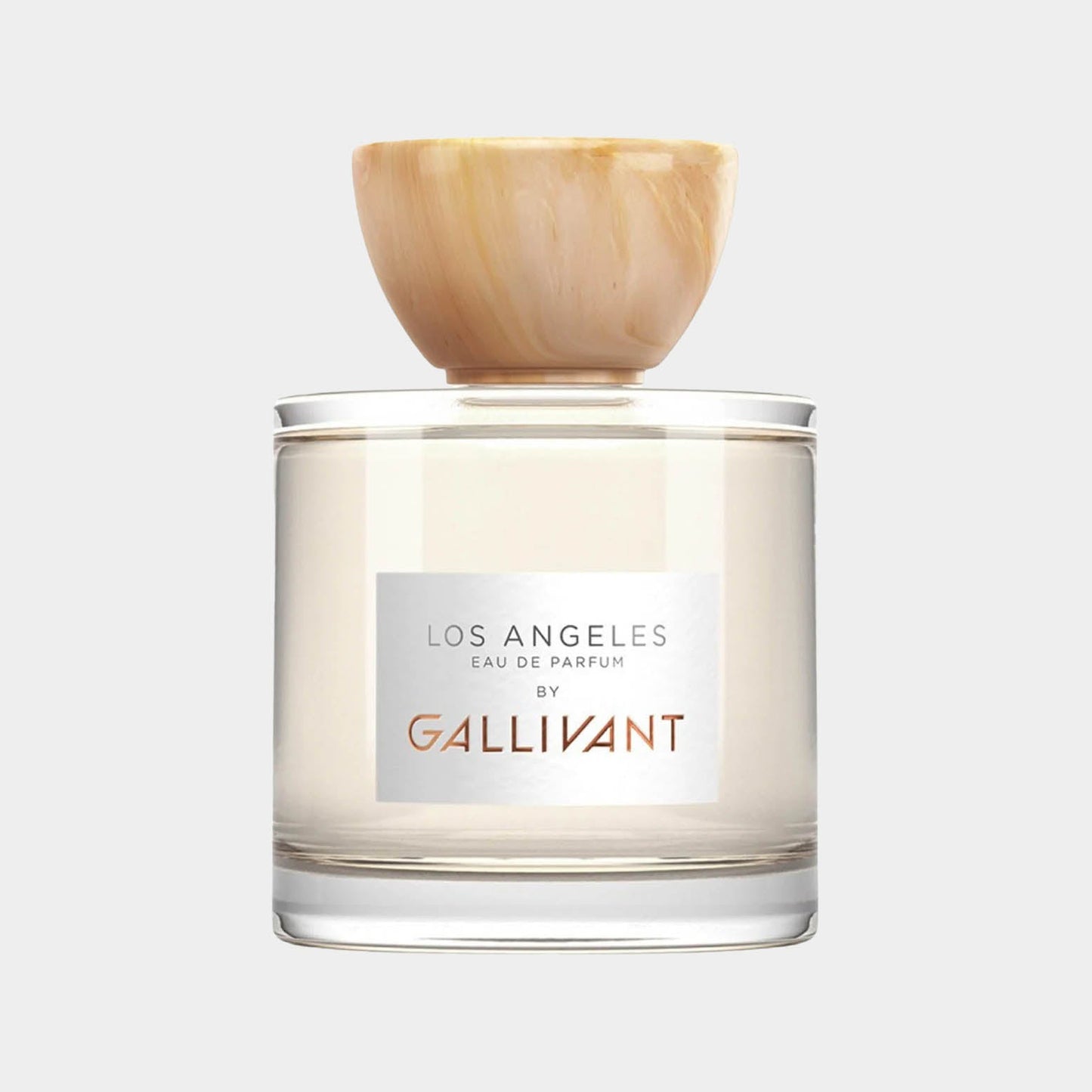 A clear glass perfume bottle features a natural stone cap, labeled Los Angeles Eau de Parfum by Gallivant. The elegant design highlights the fragrance's modern aesthetic.