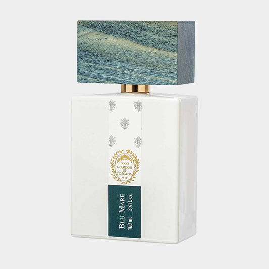 A white rectangular perfume bottle labeled Giardini di Toscana Blu Mare Sample with a textured blue cap resembling ocean waves, featuring a gold accent and floral emblem.