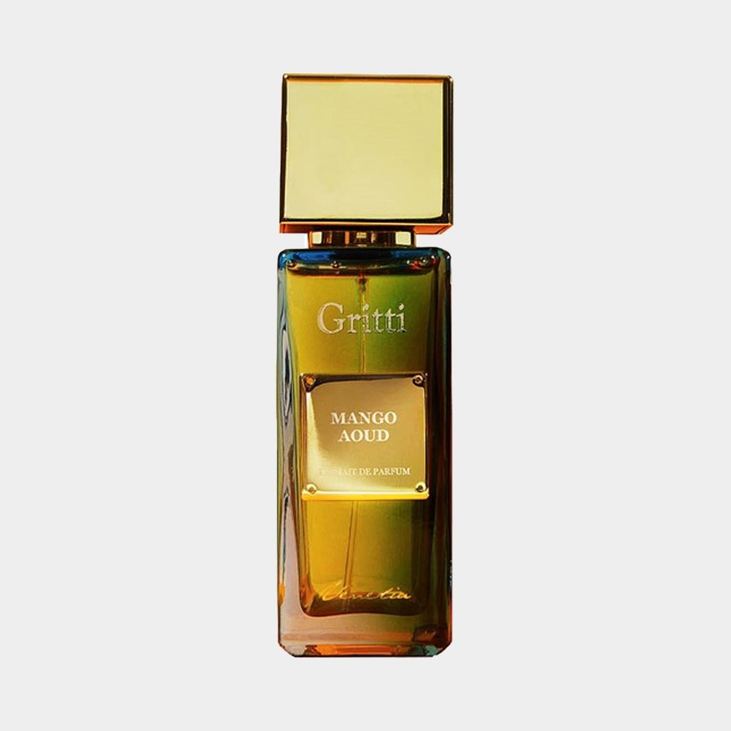 A full bottle of Gritti Mango Aoud perfume, featuring an elegant design with a gold cap and amber-hued glass that reflects light beautifully. The label prominently displays the name Mango Aoud.
