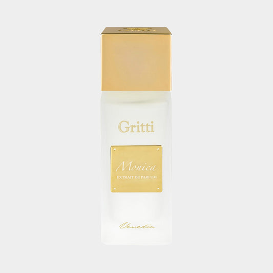 A sleek, white bottle of Gritti Monica Sample perfume with a gold cap, elegantly labeled Monica Extrait de Parfum. The minimalist design emphasizes luxury and sophistication.