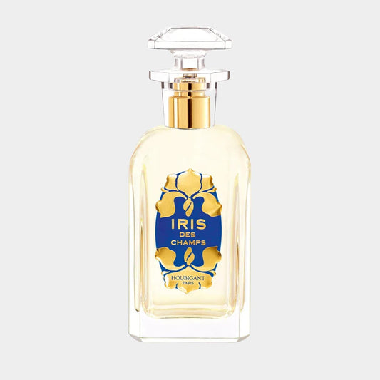 Houbigant Iris des Champs sample, featuring a clear glass bottle with a blue and gold label, elegantly topped with a crystal-like cap, showcasing the fragrance inside.