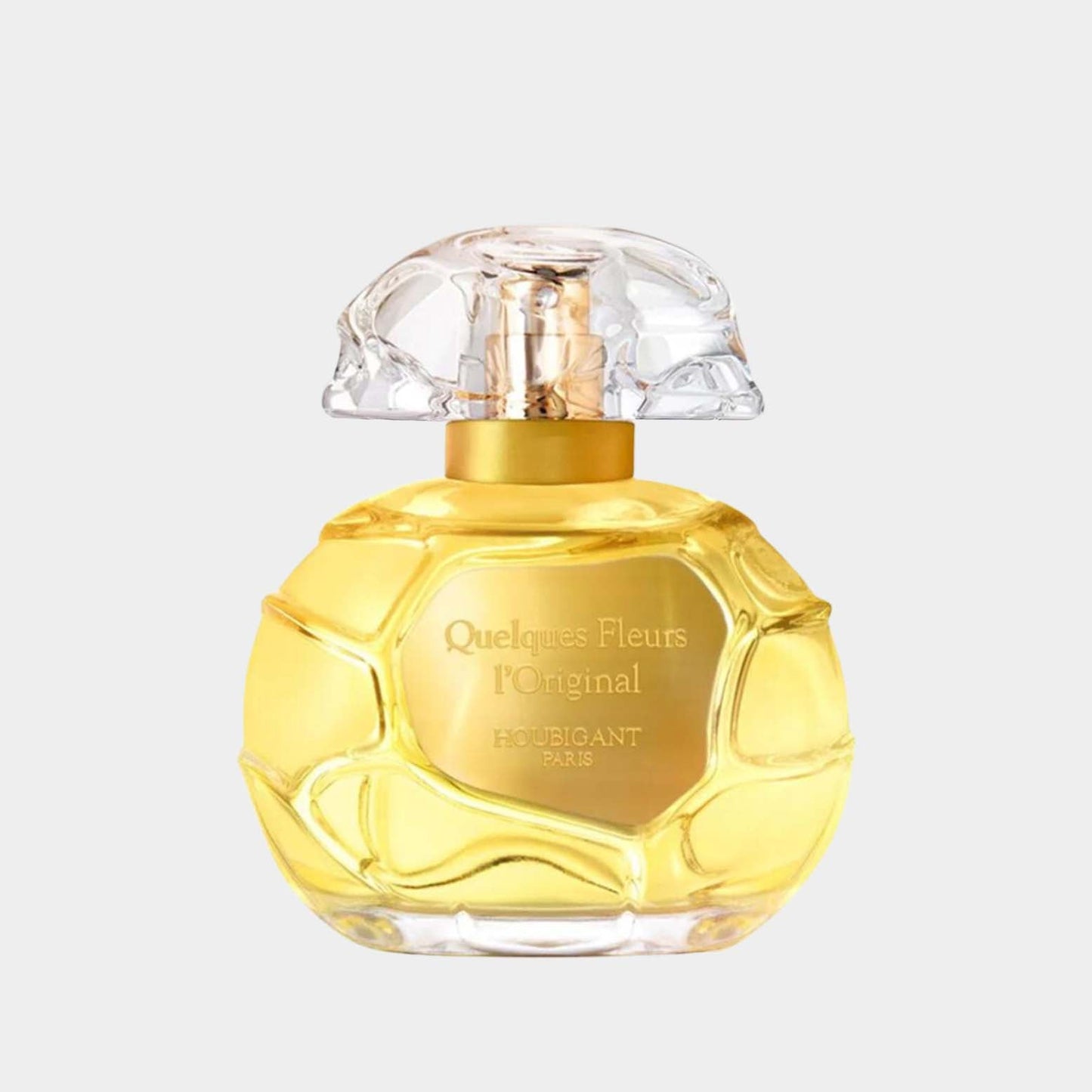 A full bottle of Houbigant Quelques Fleurs l’Original, featuring a distinctive textured glass design and a clear, elegant cap, set against a neutral background.