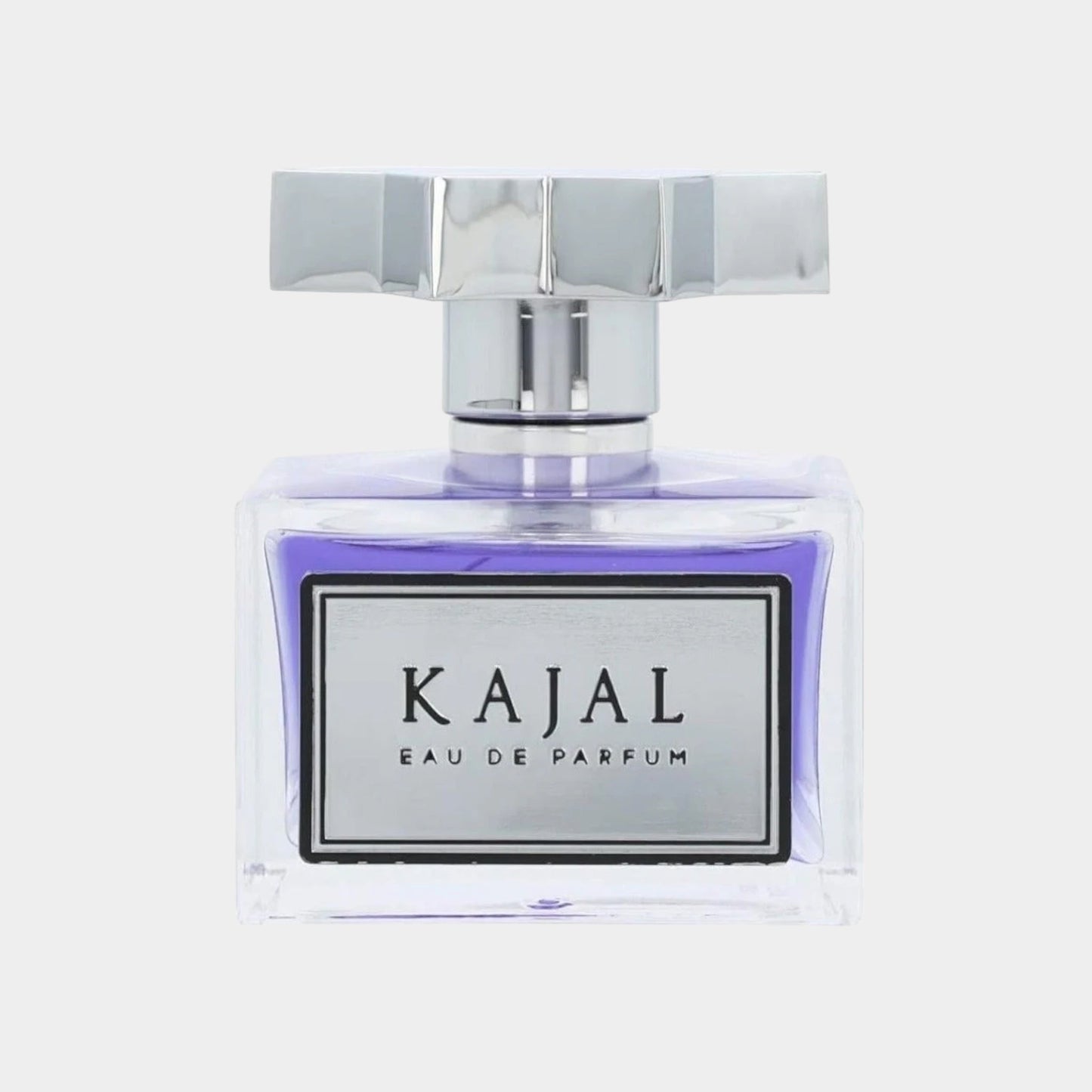 A luxurious full bottle of Kajal Eau de Parfum, featuring a clear glass design with a purple interior and a stylish silver cap. The elegant label prominently displays the brand name Kajal.