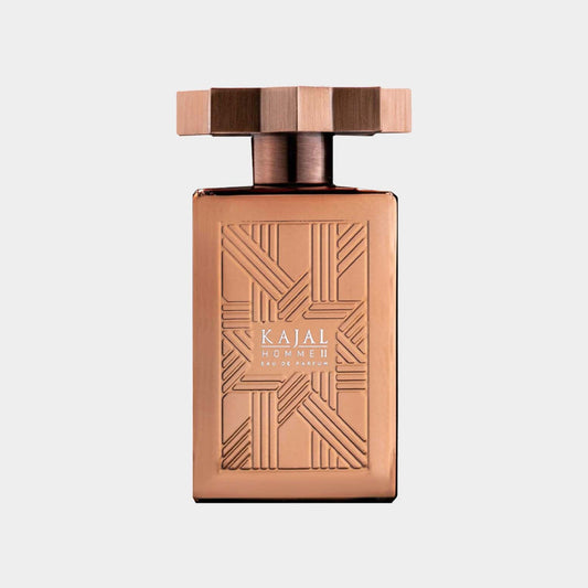 A sleek, rose gold bottle of 'Kajal Homme II Sample' perfume featuring an intricate geometric design on the front and a stylish cap. The elegant packaging suggests a sophisticated scent for men.