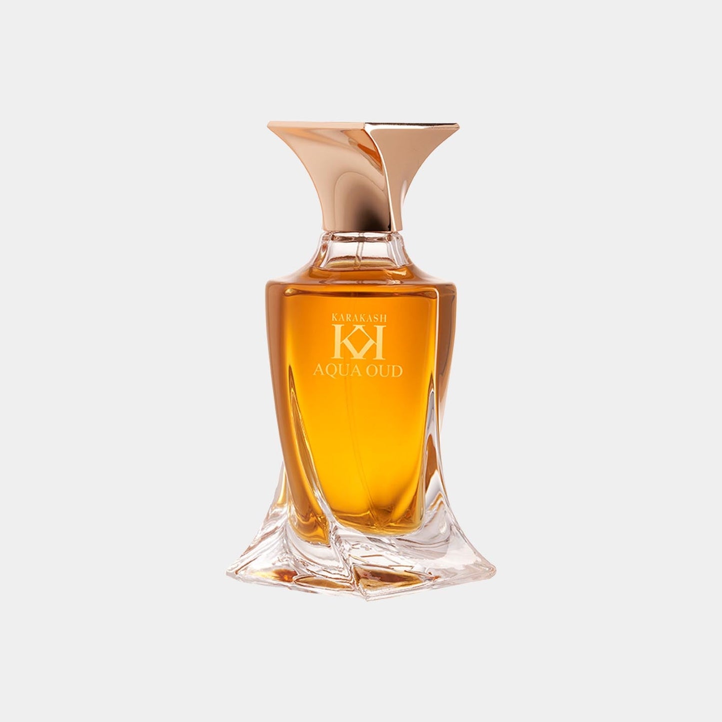 A glass perfume bottle of Karakash Aqua Oud, featuring an elegant design with a gold cap and a rich amber liquid. The label prominently displays the name Karakash Aqua Oud.
