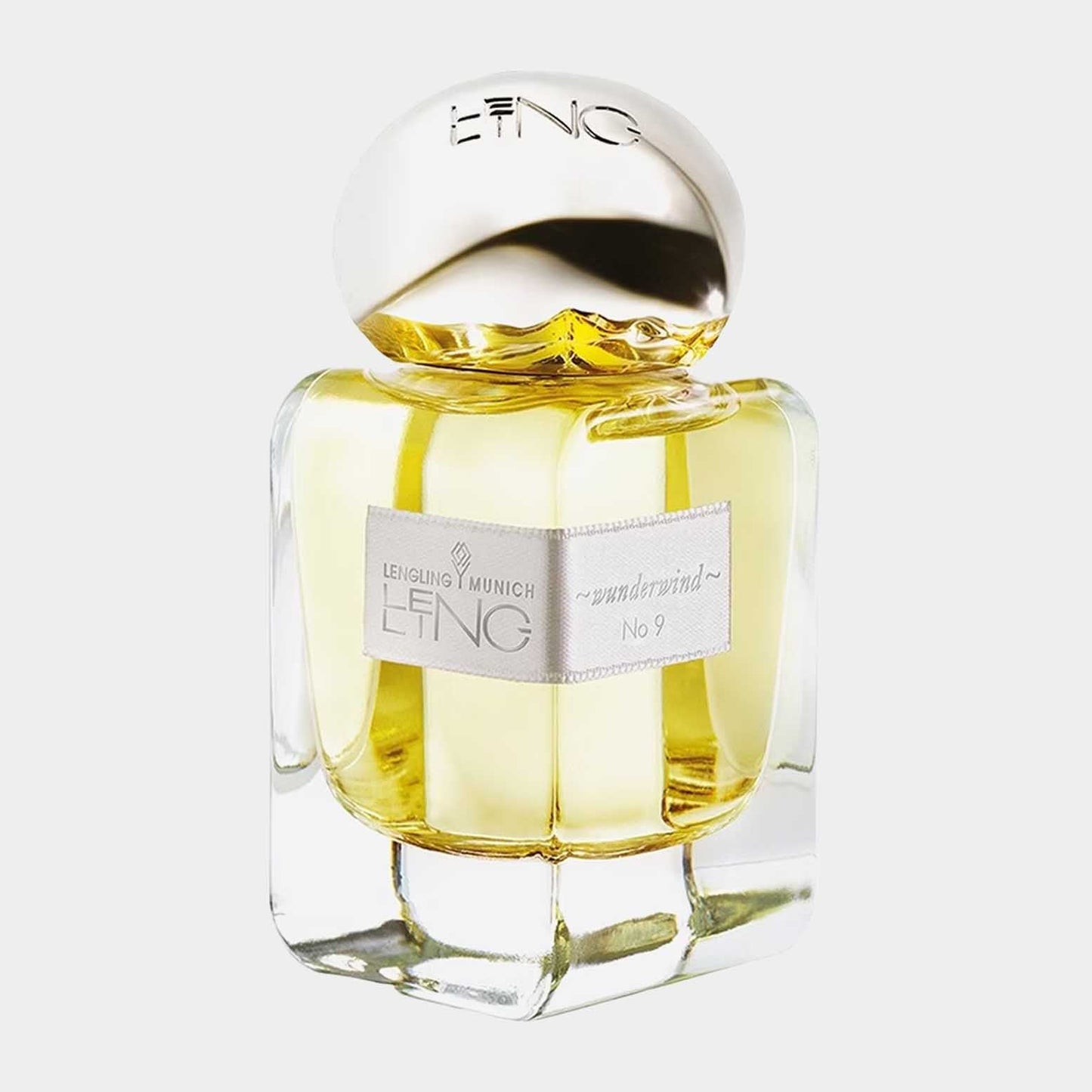 A full bottle of Lengling No.9 - Wunderwind, displayed in an elegant glass container with a gold-accented cap, showcasing a warm, golden fragrance inside. The minimalist design features a label that highlights the fragrance name and brand.