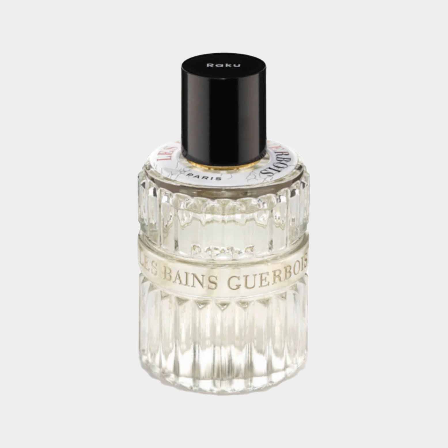 A sample bottle of Les Bains Guerbois Raku EDP, featuring a textured glass design and a sleek black cap, with a label displaying the brand name.