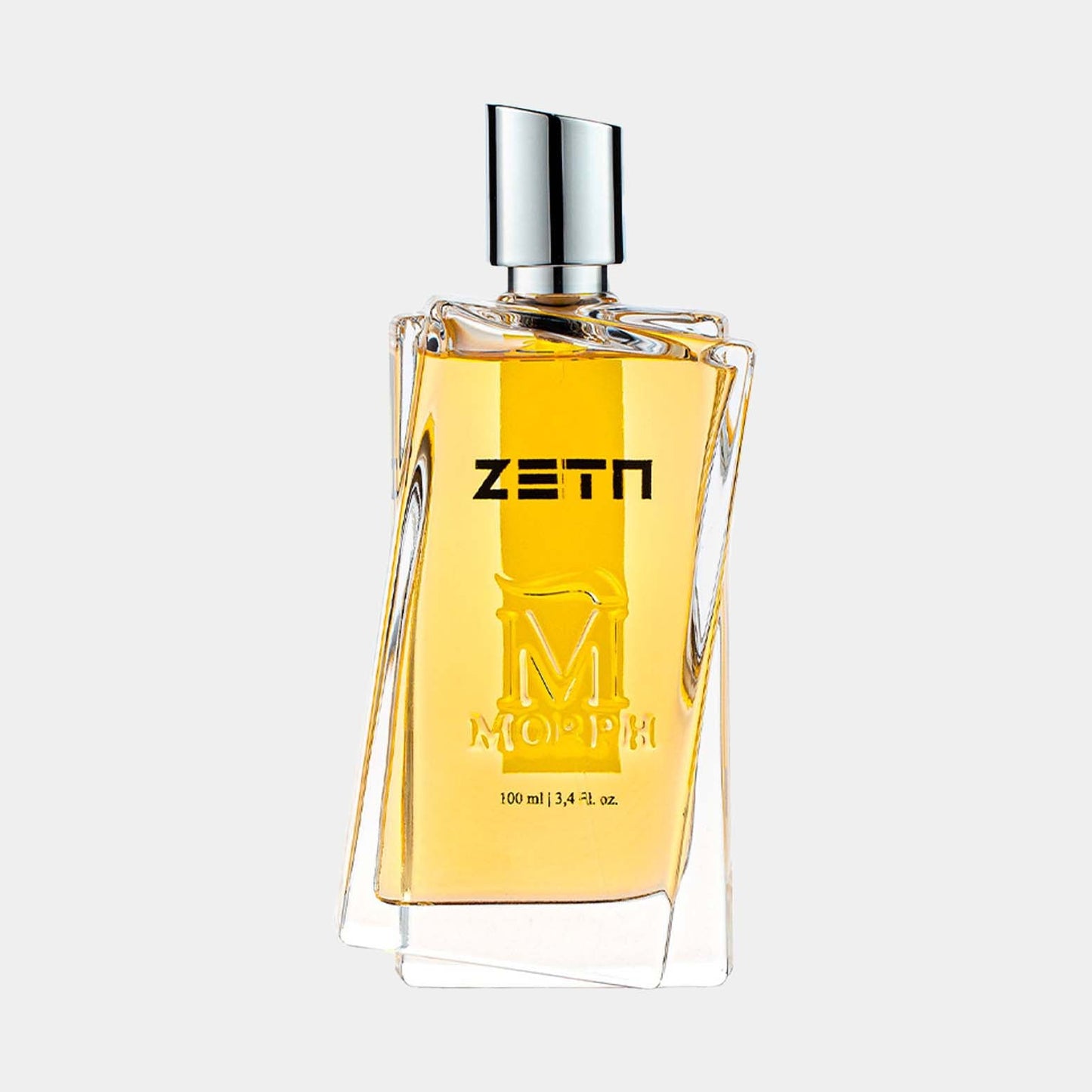 A sleek, modern bottle of Morph Zeta fragrance, featuring a clear glass design with angular edges and a metallic cap. The label displays ZETN prominently, and the bottle holds 100 ml (3.4 fl. oz.) of the golden-yellow perfume.