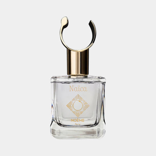 Noème Paris Naïca Sample fragrance bottle featuring a clear glass design with a gold accent cap and a distinctive circular handle.
