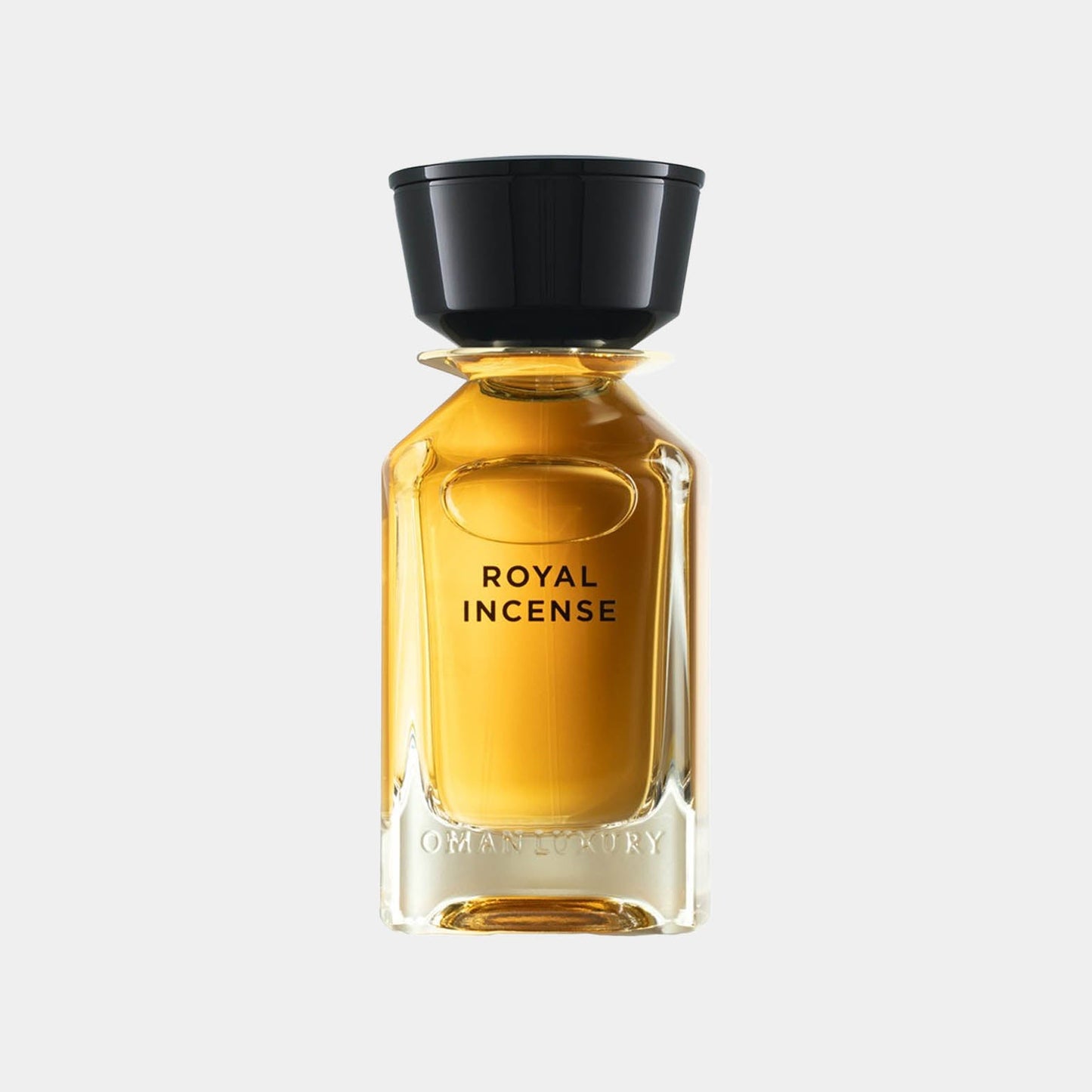 A bottle of Omanluxury Royal Incense Sample, featuring a sleek glass design and a black cap, filled with a rich amber liquid. The label displays the words Royal Incense prominently.