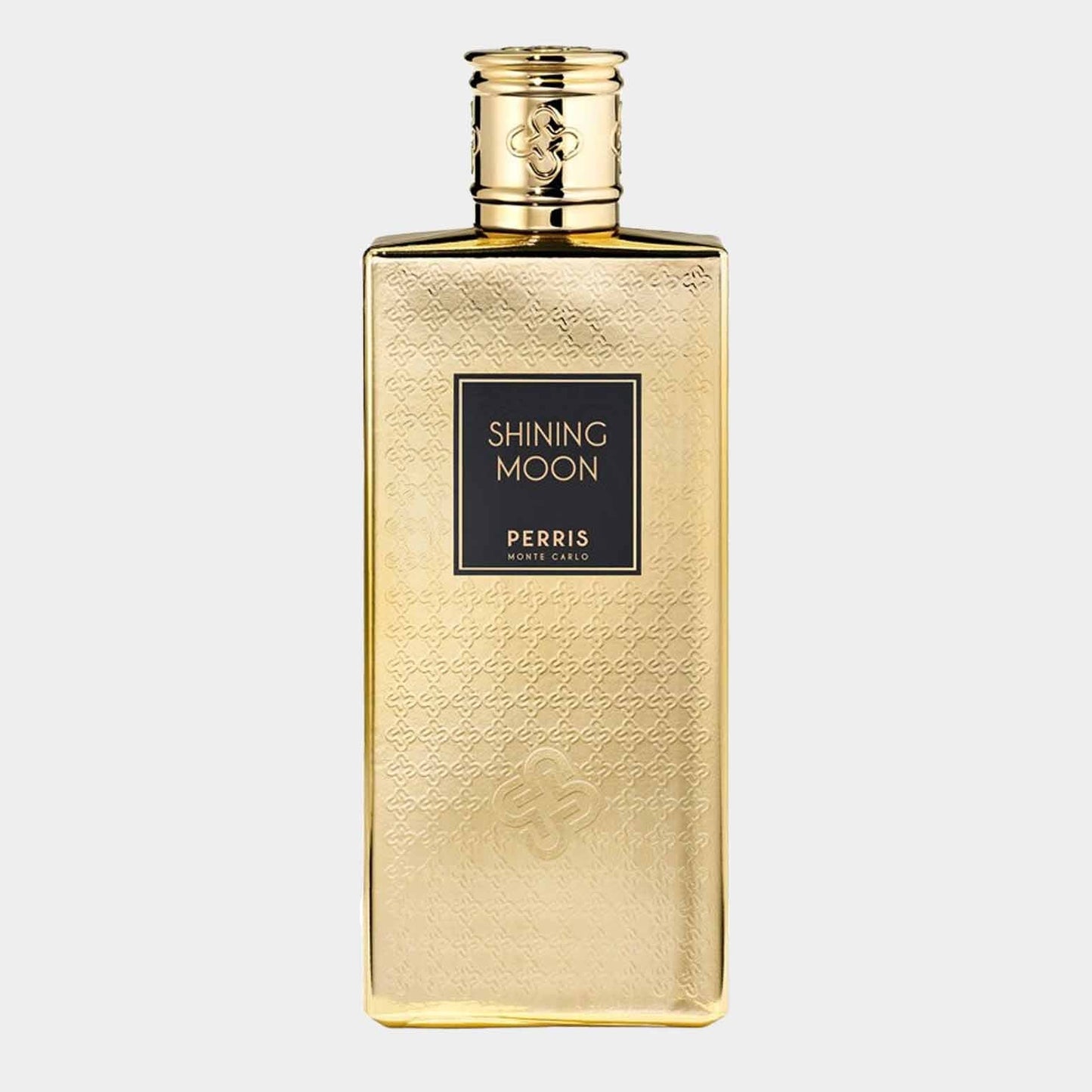 A full bottle of Perris Monte Carlo Shining Moon, featuring an elegant gold-patterned design with a sleek rectangular shape and a sophisticated cap. The label prominently displays the fragrance name and brand.