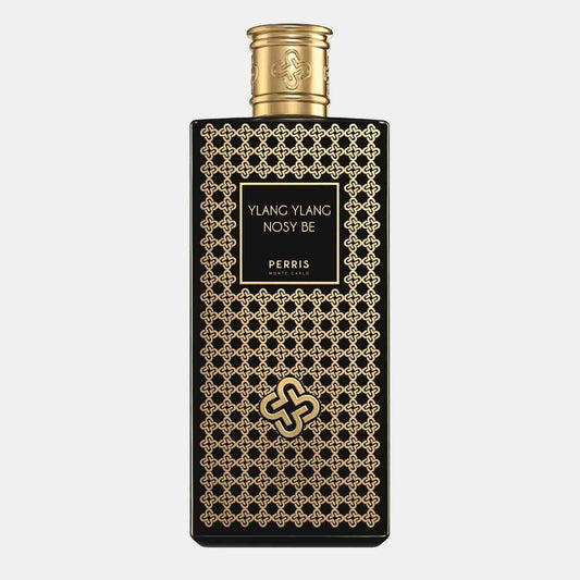 A sleek black bottle adorned with intricate gold patterns, featuring the label Perris Monte Carlo Ylang-Ylang Nosy Be Sample. The elegant design reflects the luxurious nature of the fragrance within.