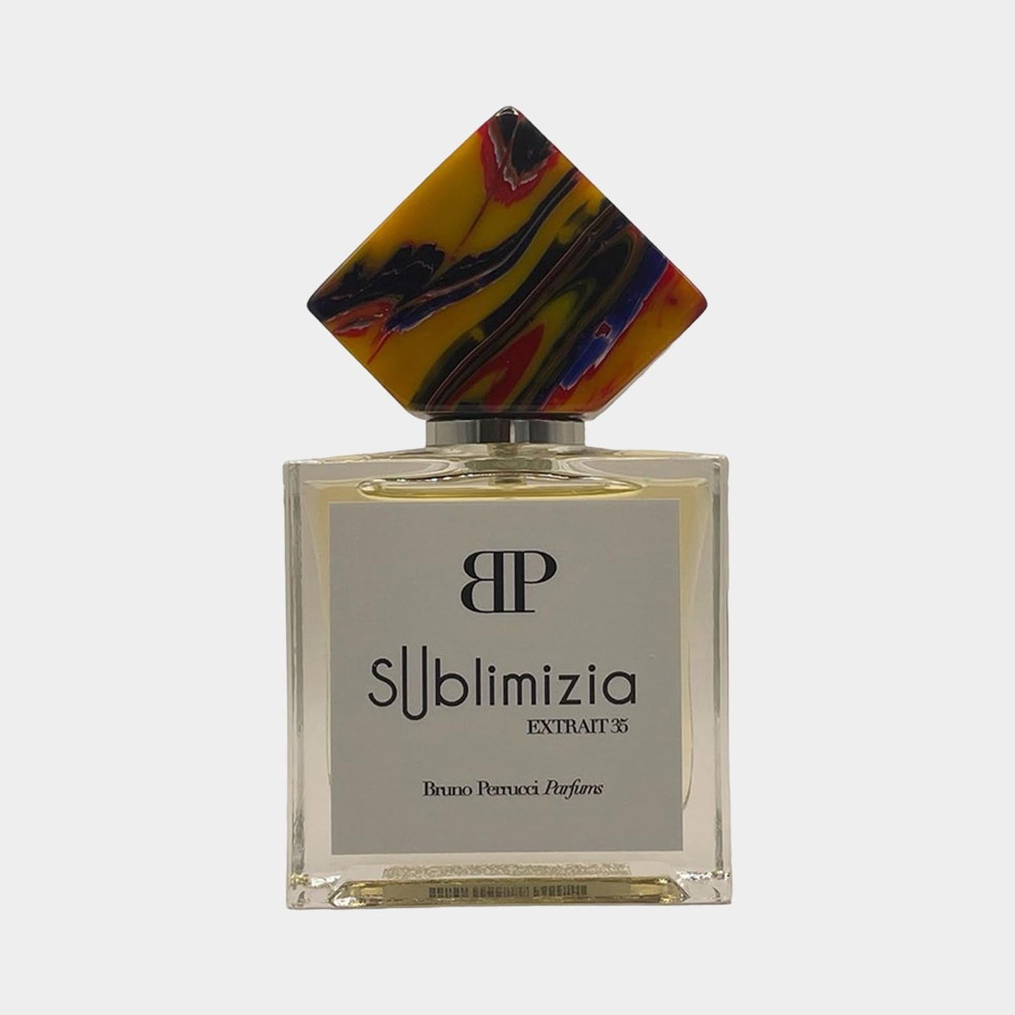 A full bottle of Bruno Perrucci Sublimizia perfume, featuring an elegant square glass design and a colorful, artistic cap. The label displays the brand name and fragrance type prominently.